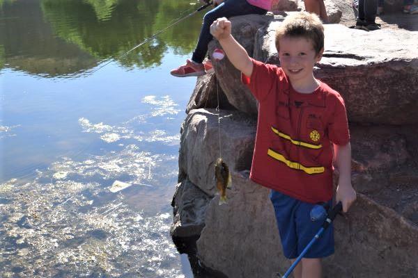 Boy with fish at Pathfinder pond